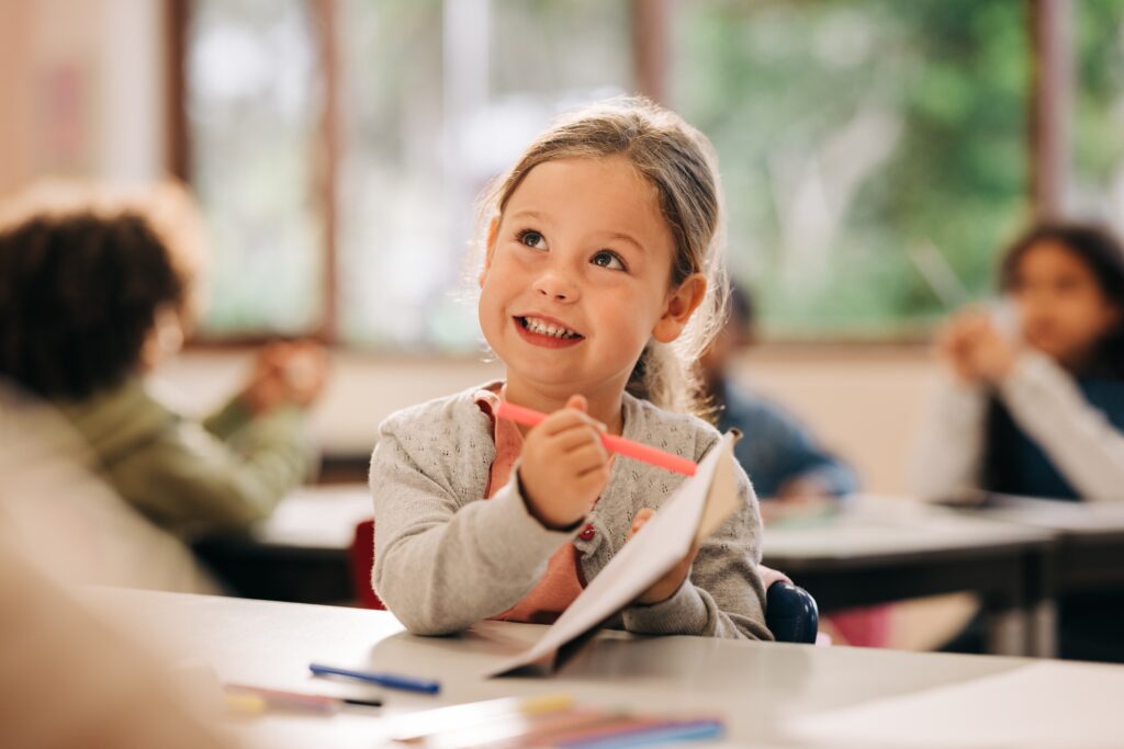 Young student pointing to high quality instructional materials