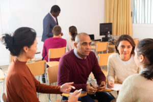 Small group of four teachers engaging in a discussion as part of their curriculum-based professional learning